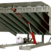 Heavy-duty hydraulic loading dock leveler with hinged lip and hydraulic lift system for safe, efficient truck loading and unloading.