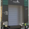 Rigid frame dock shelter with foam side pads and head curtain for weather-tight trailer sealing.