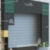 Dock shelter with foam side pads and head curtain designed to create a weather-tight trailer seal.
