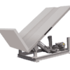 Hydraulic upender with steel platform designed to tilt and position heavy materials for handling.