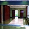 Rolling security grille installed in a school hallway providing visibility and controlled access.