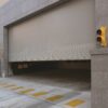 Insulated rolling steel door opening at a loading dock to provide secure trailer access and sealing.