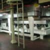 Industrial machinery platform with metal ladder and support frame