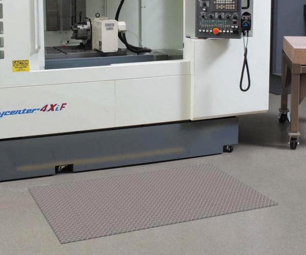 Switchboard Diamond Deckplate floor mat in front of CNC
