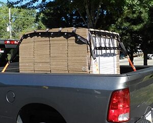 Truck Bed Cargo Net securing skid to truck bed