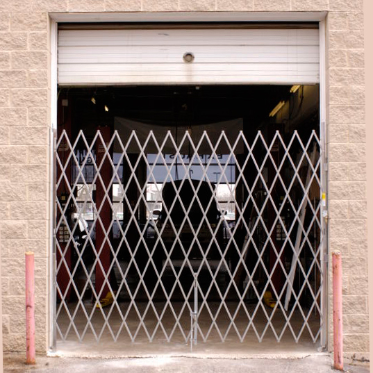 Heavy Duty Single Folding Gate in front of an overhead door