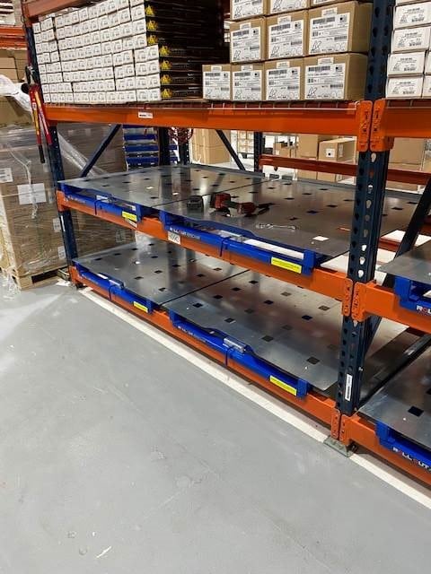 Rack mounted roll out pallet