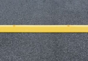 A yellow plastic speed bump from Barron Equipment.