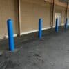 0.25 Inch Thick Nominal Bollard Covers in use near building in parking lot