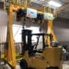 Gantry crane with dual hoists and forklift below