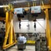 Gantry crane with dual hoists in fabrication area